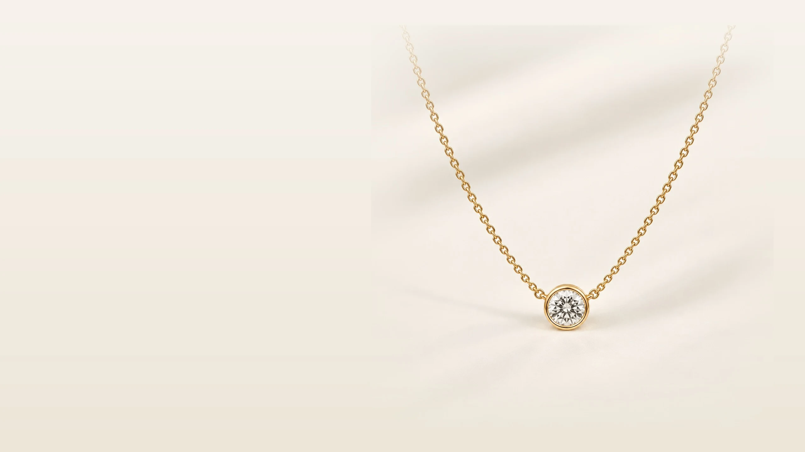 Bezel-set Lab-Grown Diamond necklace resting in soft folds of ivory fabric